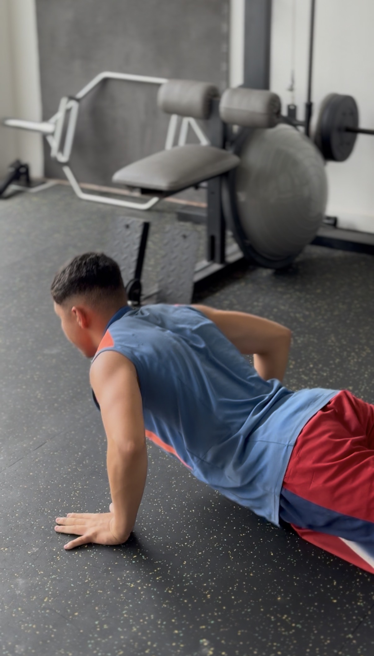 Socio haciendo flexiones en el piso del gimnasio